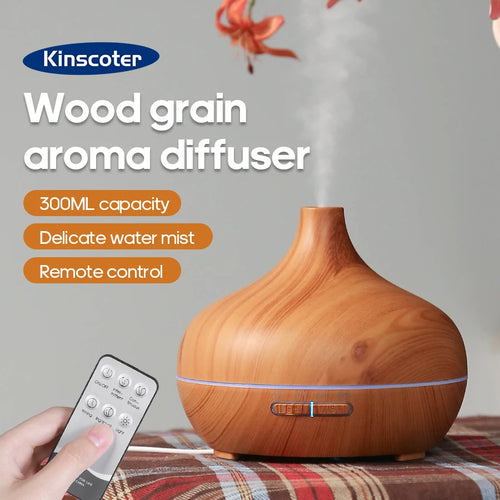 Wood grain aroma diffuser with remote control by Kinscoter on a plaid surface.